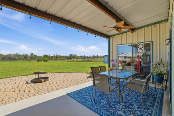 a view of swimming pool with outdoor seating and a yard