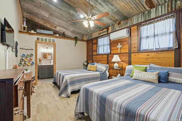 a bedroom with two beds and a chandelier
