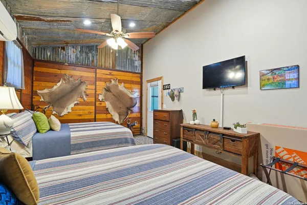 a bedroom with a bed and a flat screen tv