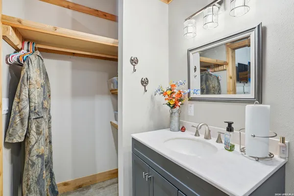 a bathroom with a sink vanity and a mirror