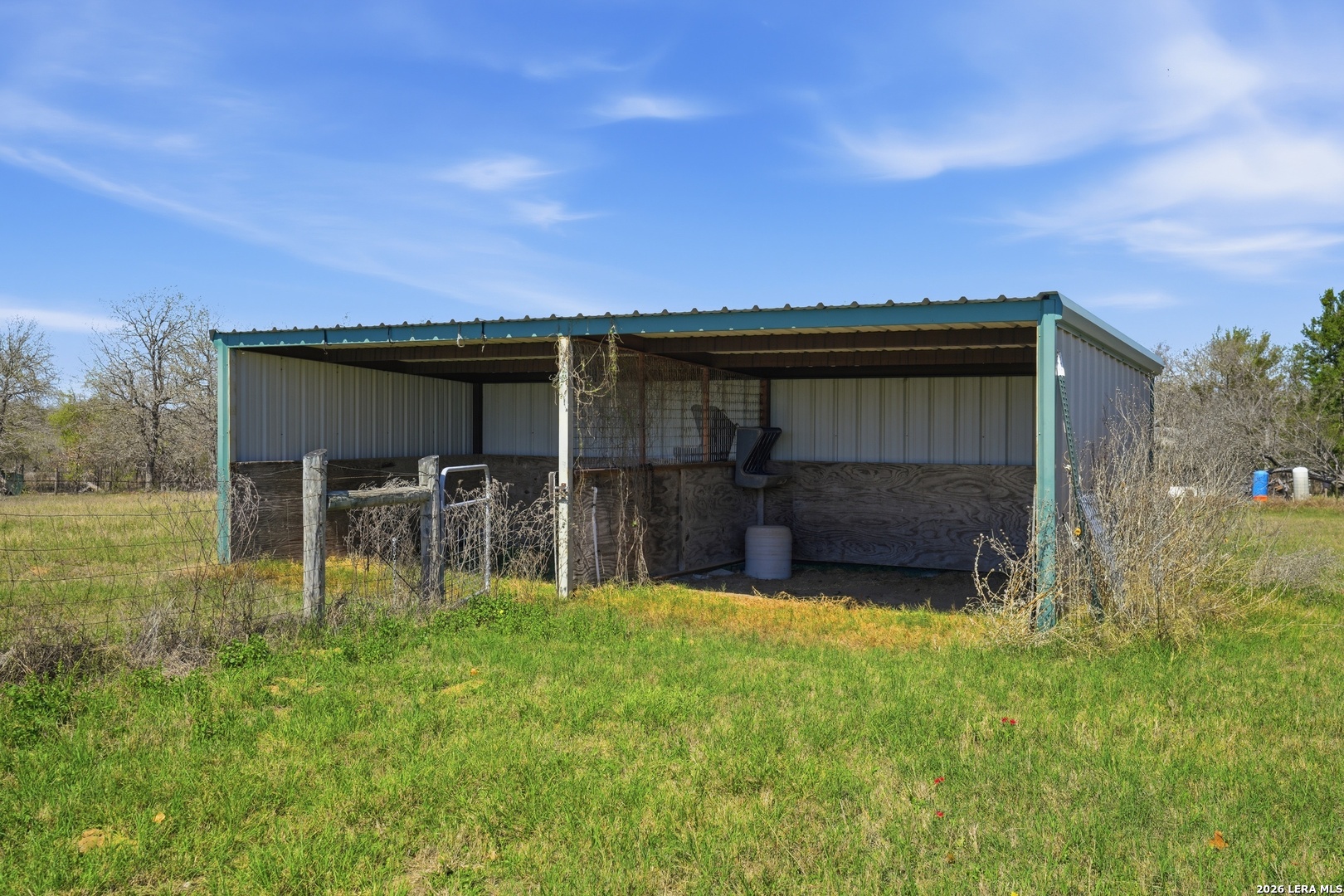 293 Woodrow Center Road Kingsbury, TX 78638 - Photo 42 of 50 a backyard of a house with table and chairs