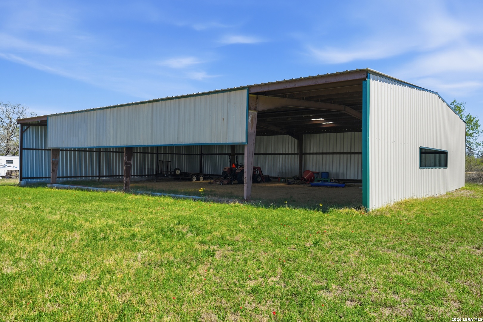 293 Woodrow Center Road Kingsbury, TX 78638 - Photo 43 of 50 a view of a backyard with potted plants and a table