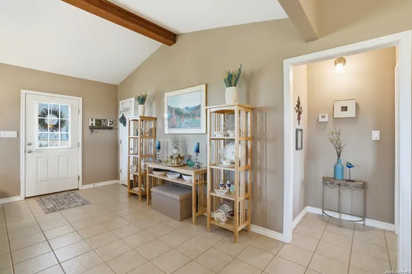 a view of a livingroom with furniture and refrigerator