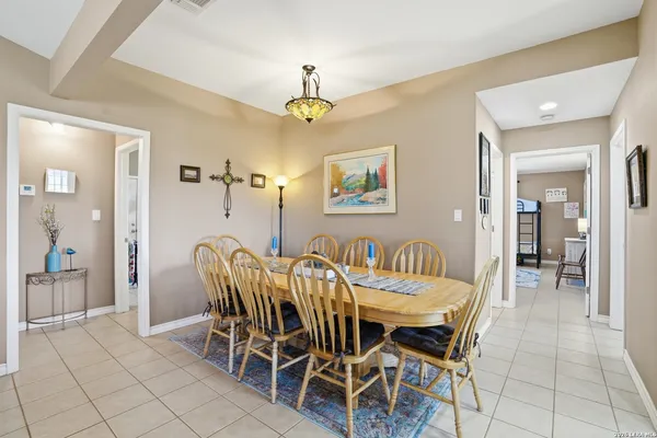 a view of a dining room with furniture and chandelier