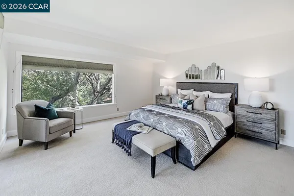 a bed sitting in a bedroom next to a window