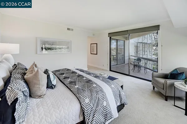 a bedroom with a bed and a lamp