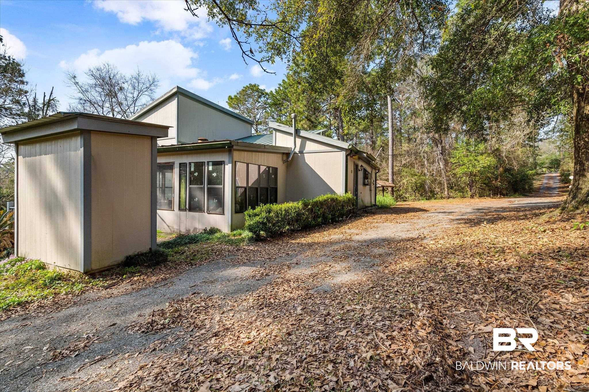 8451 Nugget Drive Mobile, AL 36695 - Photo 3 of 12 View of home's exterior with a sunroom
