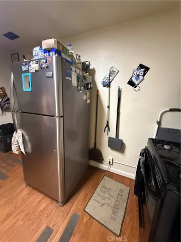 a kitchen with kitchen island granite countertop a stove and a sink