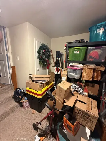a bedroom with bed and a chandelier