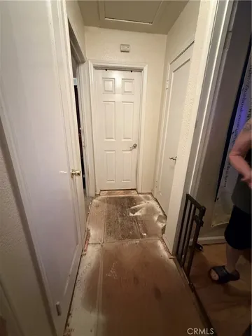 a bed sitting in a bedroom and dresser with wooden floor