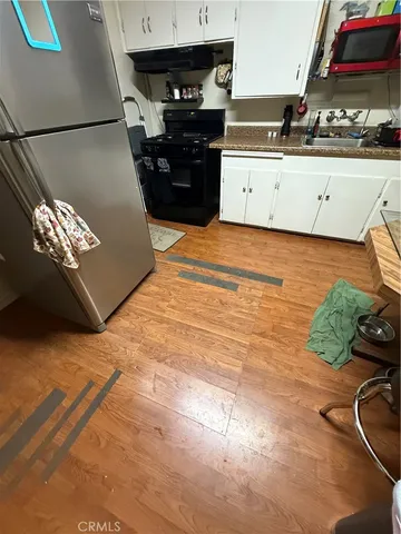 a kitchen with stainless steel appliances granite countertop a stove and a cabinets