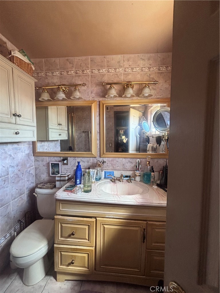 19221 Scobey Avenue Carson, CA 90746 - Photo 7 of 15 a bathroom with a toilet sink and mirror