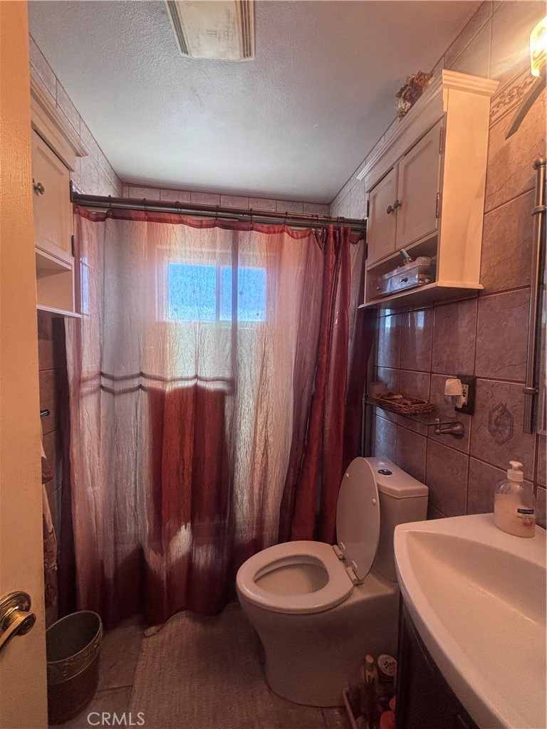 19221 Scobey Avenue Carson, CA 90746 - Photo 8 of 15 a bathroom with a sink toilet and shower