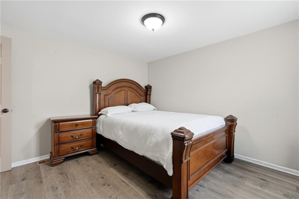 1295 Double Bridges Road Winder, GA 30680 - Photo 27 of 57 a bedroom with a bed and a dresser