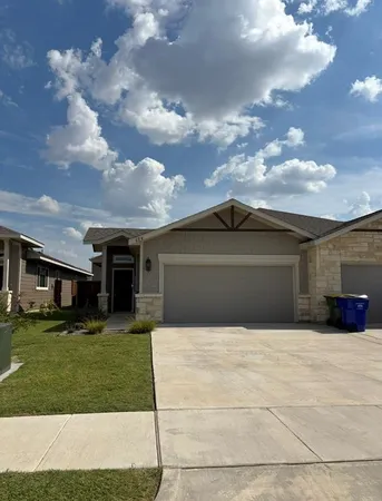 a front view of house with yard and trees