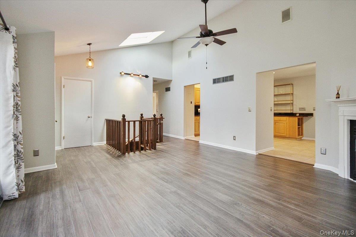 102 Old Post Road Marlboro, NY 12542 - Photo 12 of 46 an empty room with wooden floor and ceiling fan