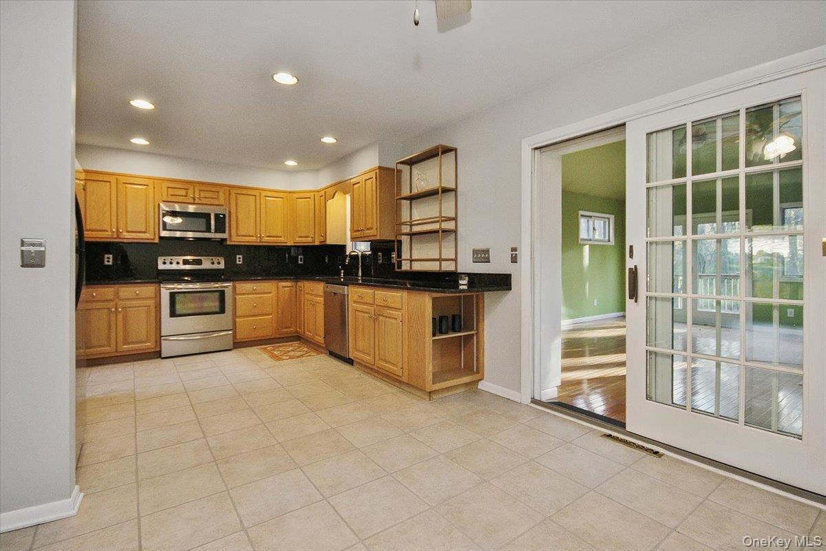 102 Old Post Road Marlboro, NY 12542 - Photo 14 of 46 a kitchen with stainless steel appliances granite countertop a stove and cabinets