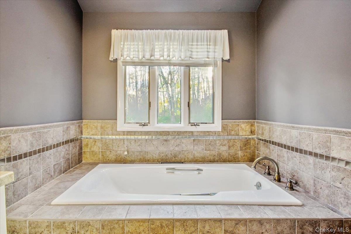 102 Old Post Road Marlboro, NY 12542 - Photo 25 of 46 a bathroom with a bath tub and a window