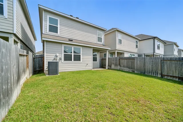 a view of a house with backyard and porch
