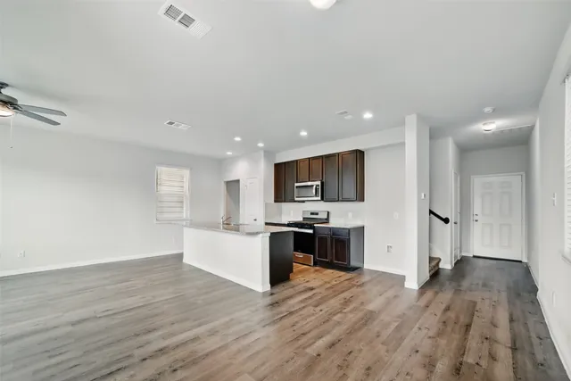 a view of kitchen with sink microwave and refrigerator
