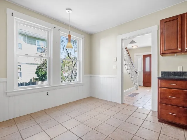 a view of hallway with window and cabinet