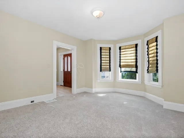 an empty room with windows and closet