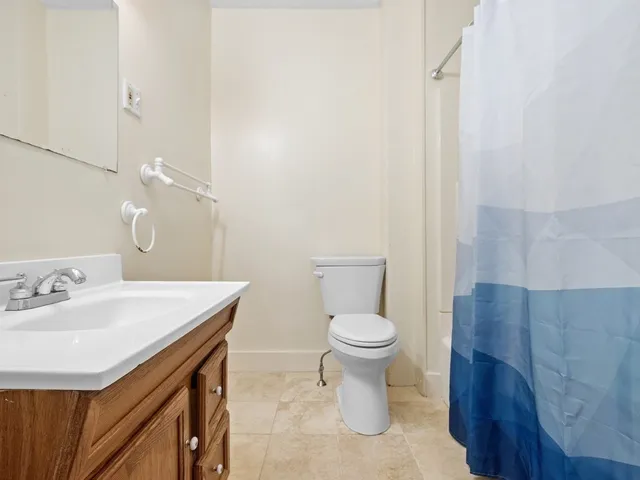 a bathroom with a sink a toilet and a mirror