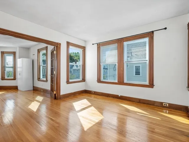 a view of an empty room with glass door