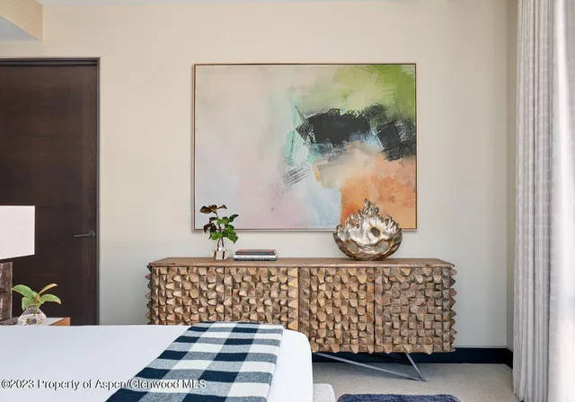 a bed room with a bed and a painting on the wall