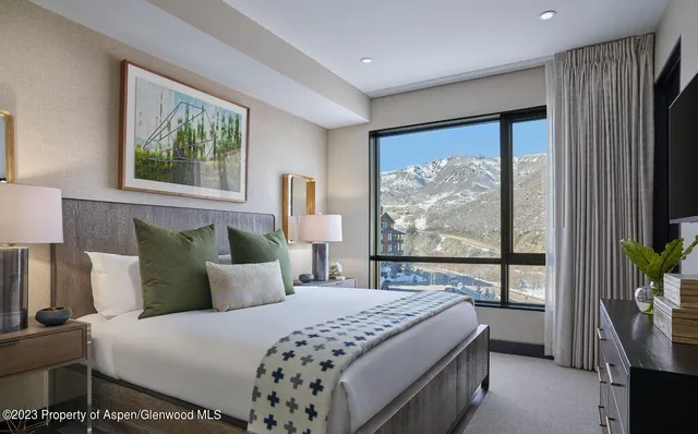 a bedroom with a large bed and a window