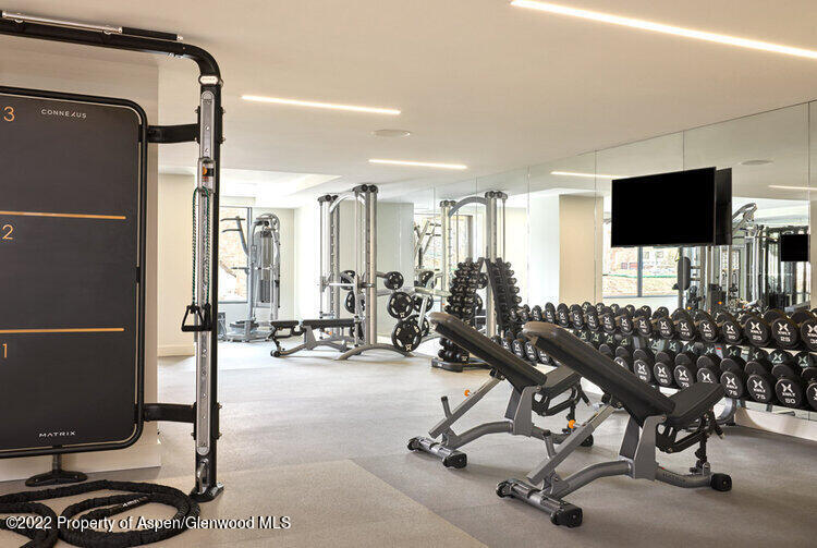 77 Wood Road, Unit 50702 Snowmass Village, CO 81615 - Photo 5 of 7 a view of a livingroom with workspace and a flat screen tv