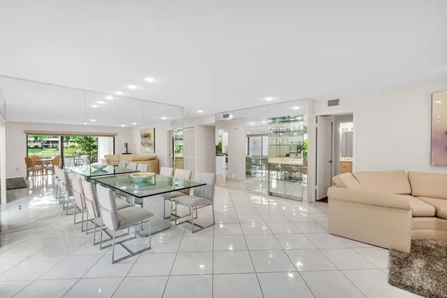 a living room with furniture a large window and breakfast area