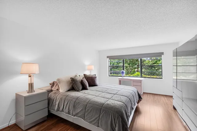 a bedroom with a bed and a large window
