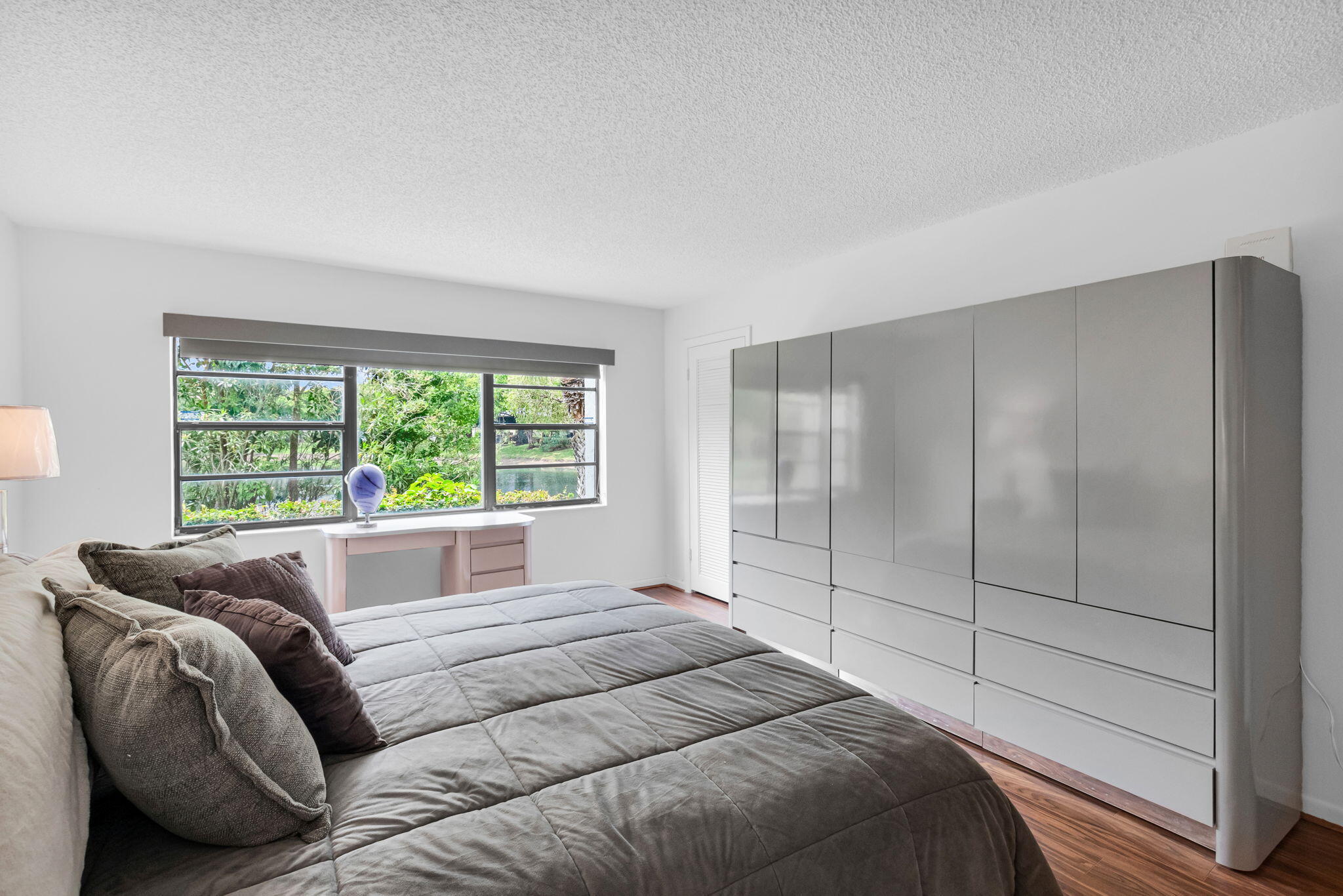 12 Westgate Lane, Unit C Boynton Beach, FL 33436 - Photo 24 of 54 a bedroom with a bed and a large window