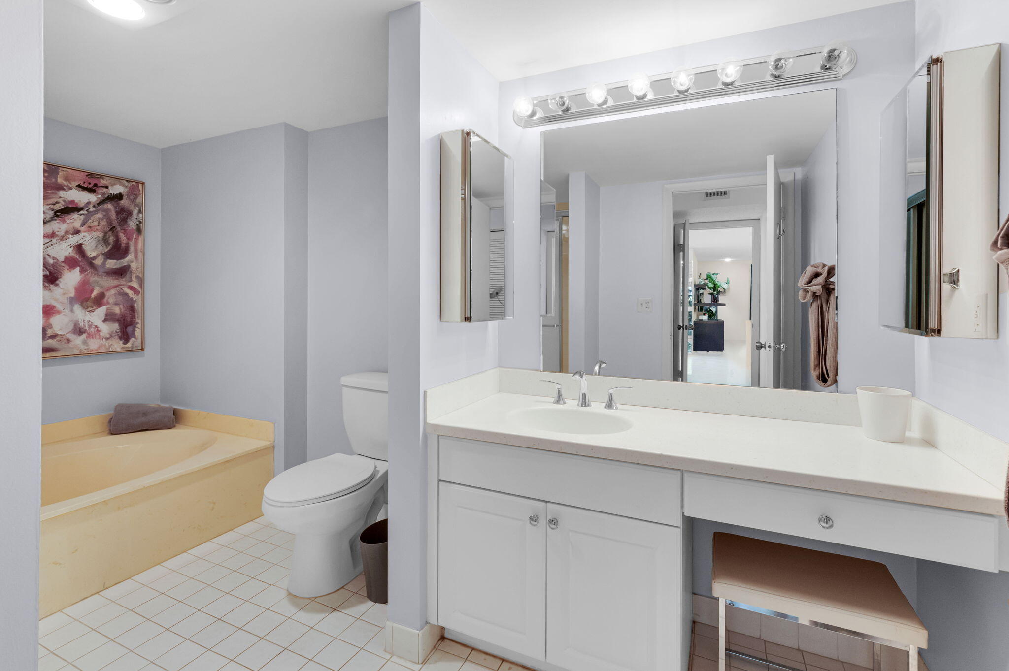 12 Westgate Lane, Unit C Boynton Beach, FL 33436 - Photo 26 of 54 a bathroom with a sink toilet a mirror and shower