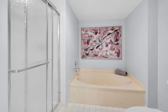 a white bath tub with a white comforter