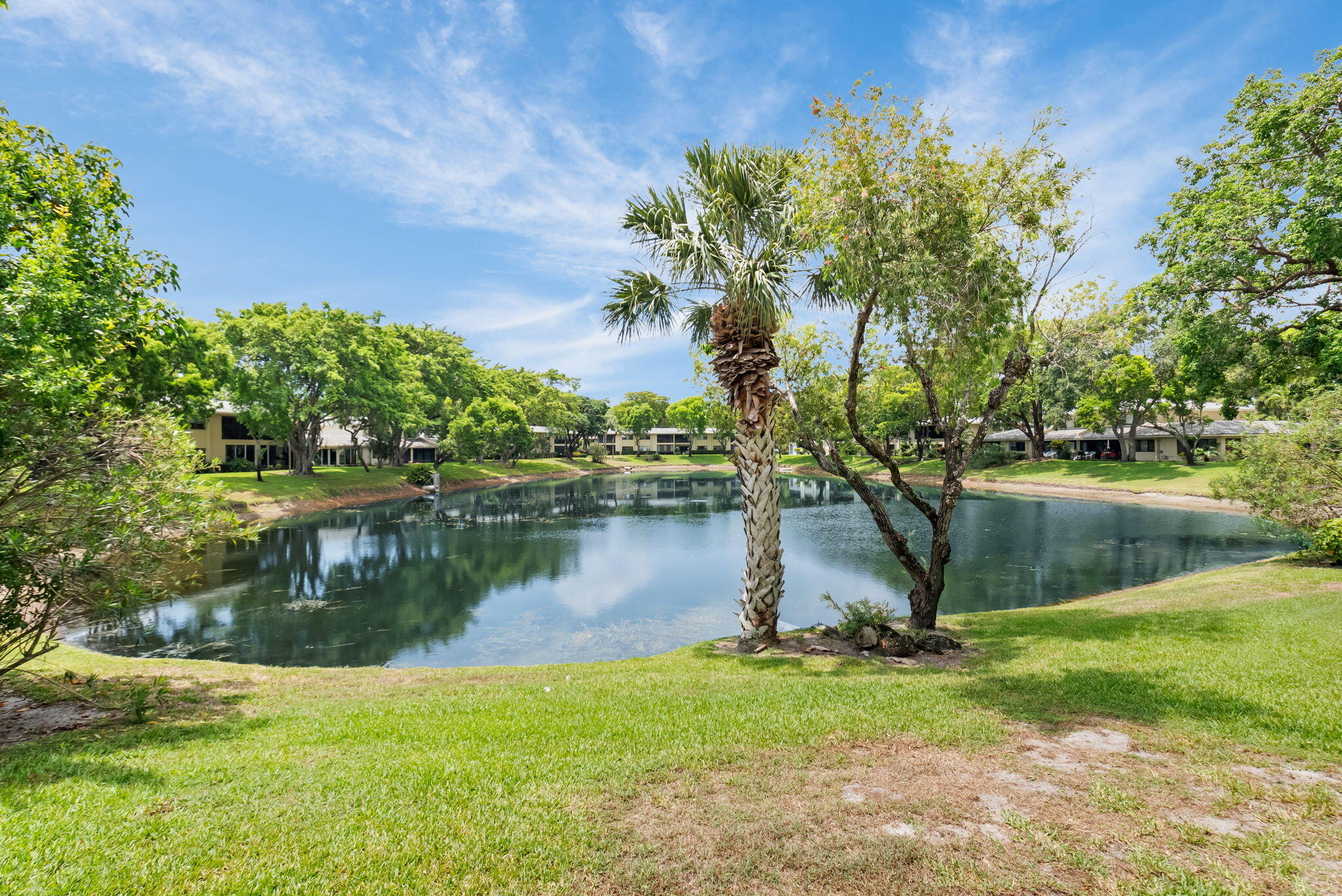 12 Westgate Lane, Unit C Boynton Beach, FL 33436 - Photo 34 of 54 a view of a lake with a house in the background
