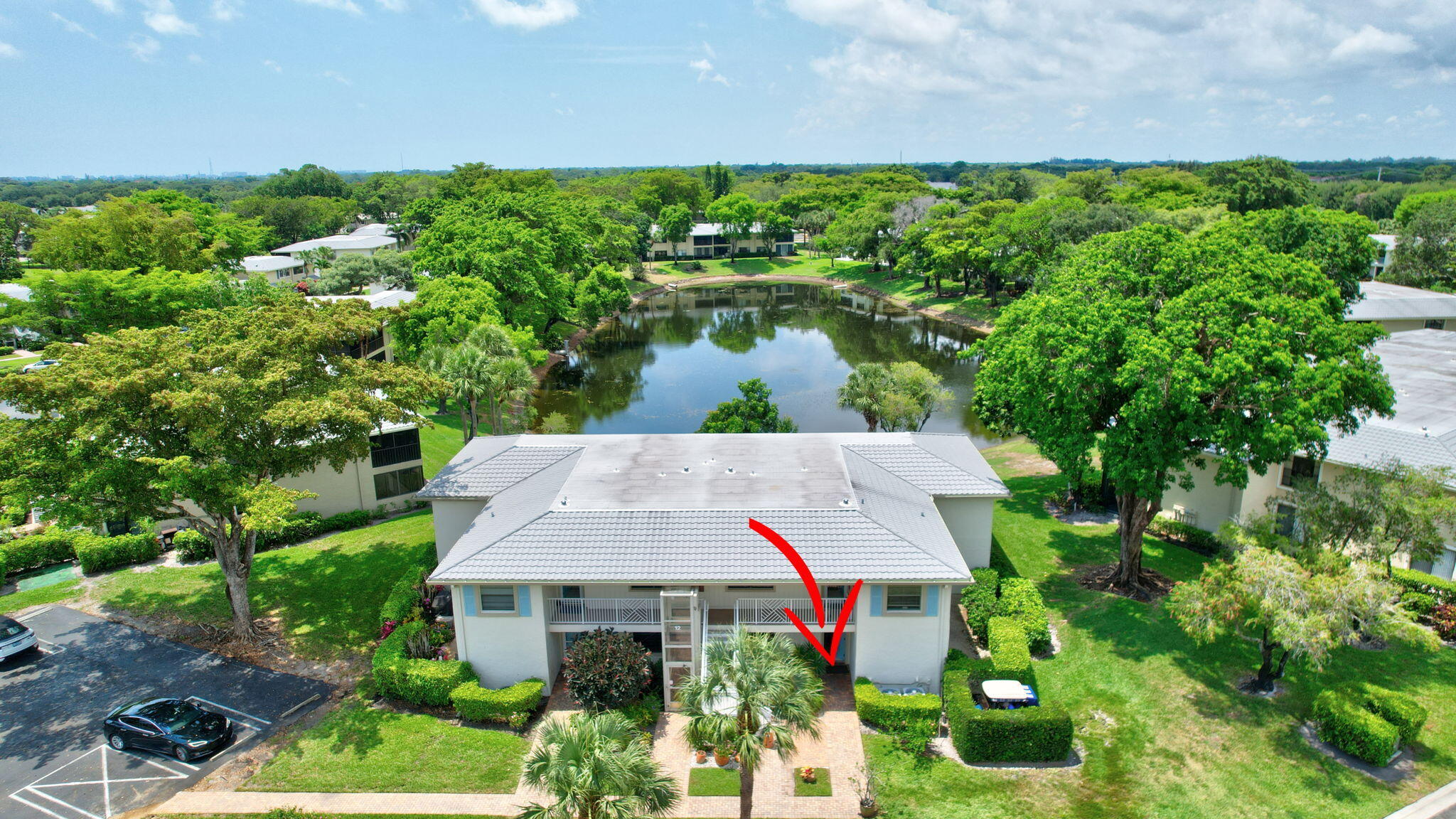 12 Westgate Lane, Unit C Boynton Beach, FL 33436 - Photo 38 of 54 a aerial view of a house with a yard and potted plants