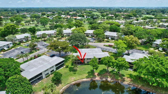 an aerial view of a house with a yard and lake view