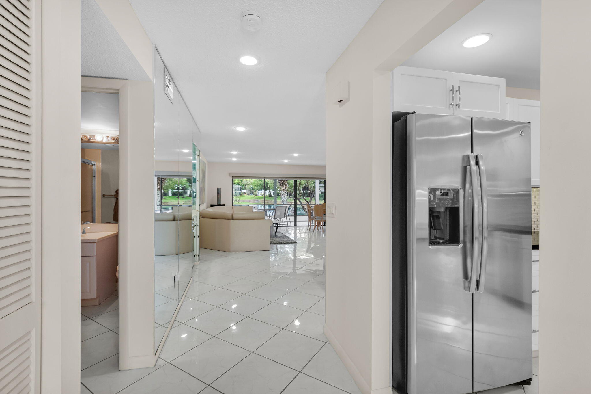 12 Westgate Lane, Unit C Boynton Beach, FL 33436 - Photo 4 of 54 a bathroom with a glass shower door and a bathroom