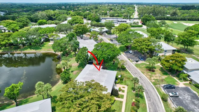 an aerial view of residential houses with outdoor space and lake view