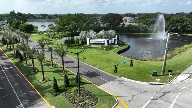 a view of a swimming pool with a patio and a garden