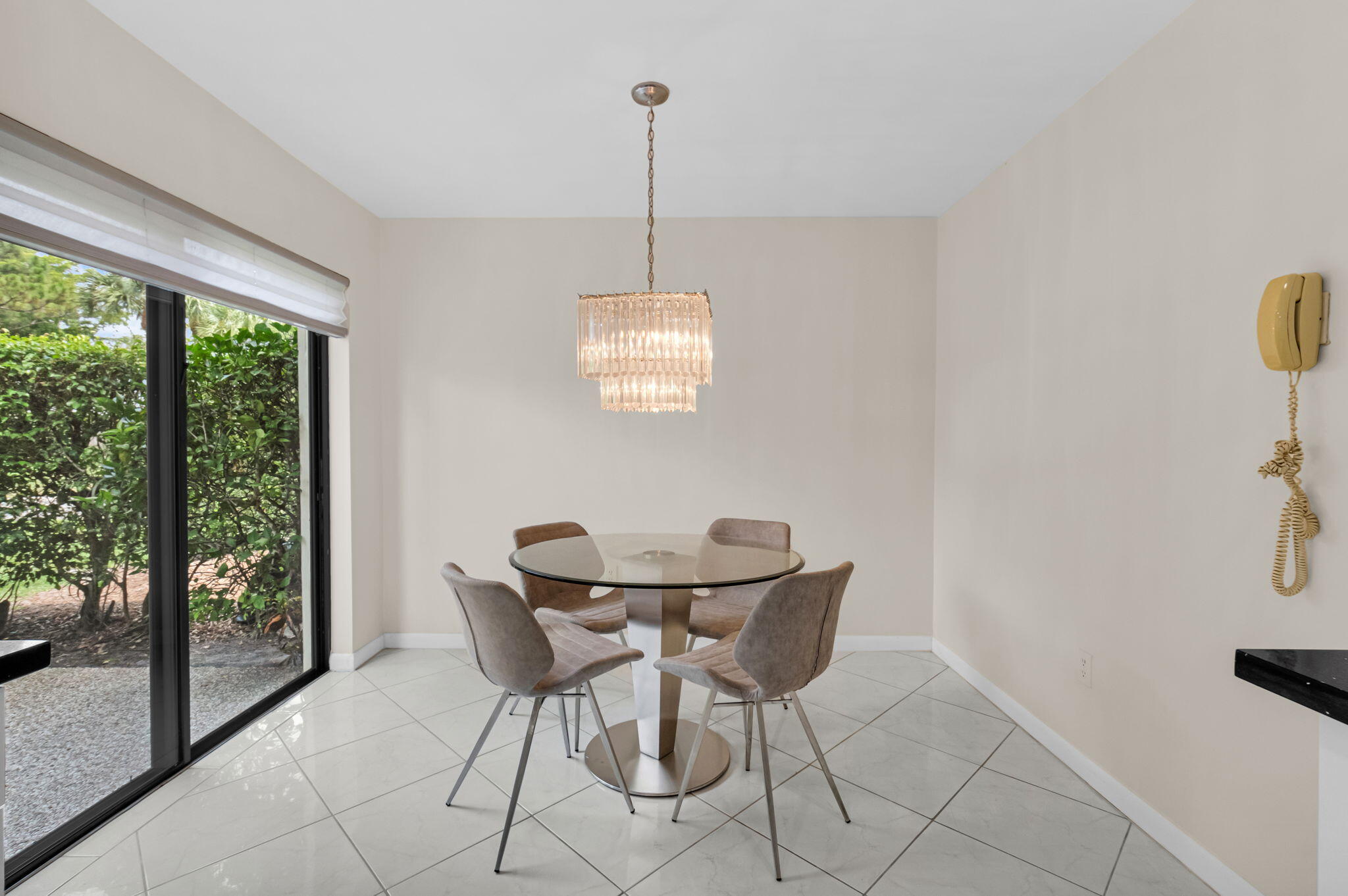 12 Westgate Lane, Unit C Boynton Beach, FL 33436 - Photo 9 of 54 a dining room with furniture and window
