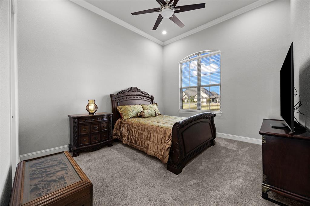 6381 Rigel Road Godley, TX 76044 - Photo 33 of 40 a bedroom with a bed and a flat tv screen on a dresser