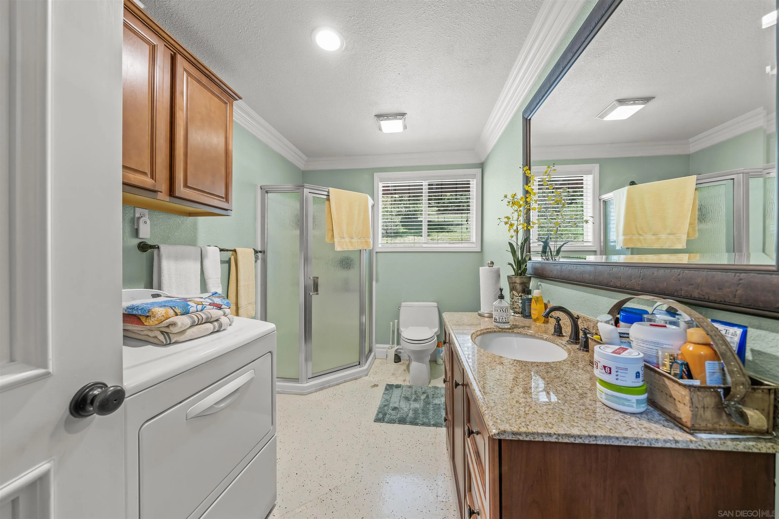 2464 Wynola Road Julian, CA 92036 - Photo 14 of 50 a kitchen with a refrigerator a stove a sink dishwasher and a dining table with wooden cabinet