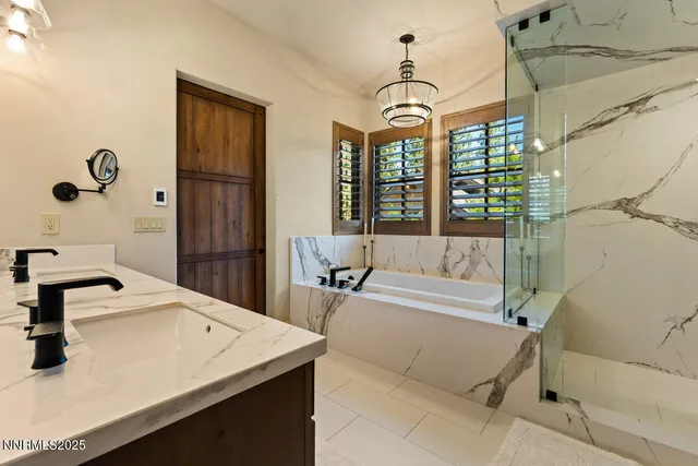a spacious bathroom with a tub sink and mirror