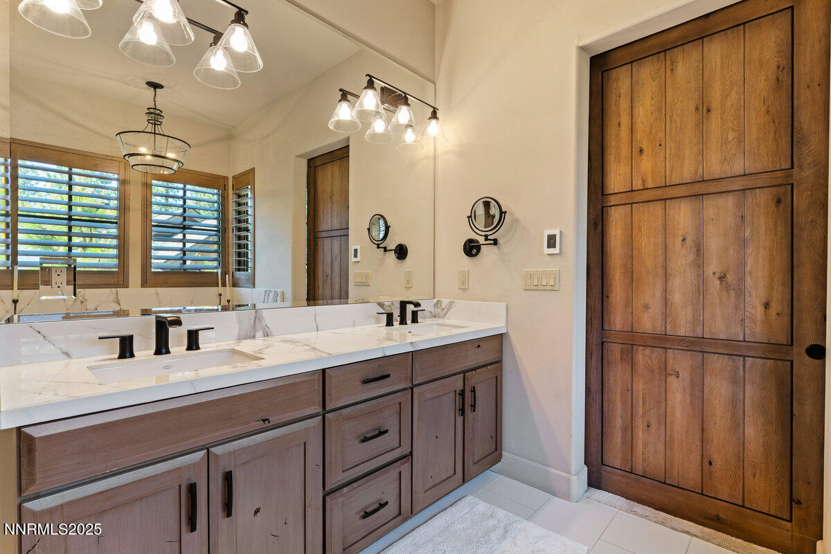 253 Mill Race Loop Carson City, NV 89705 - Photo 12 of 44 a bathroom with a double vanity sink mirror and shower