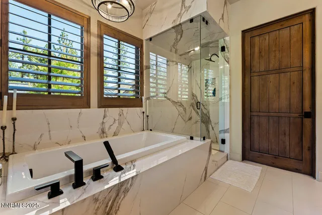 a bathroom with a tub sink and shower