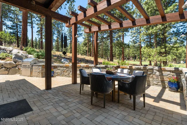 a view of a patio with a dining table and chairs