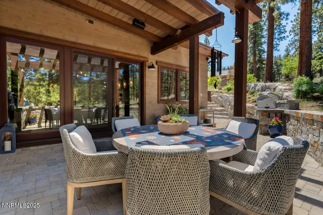 a view of an outdoor dining space with a patio